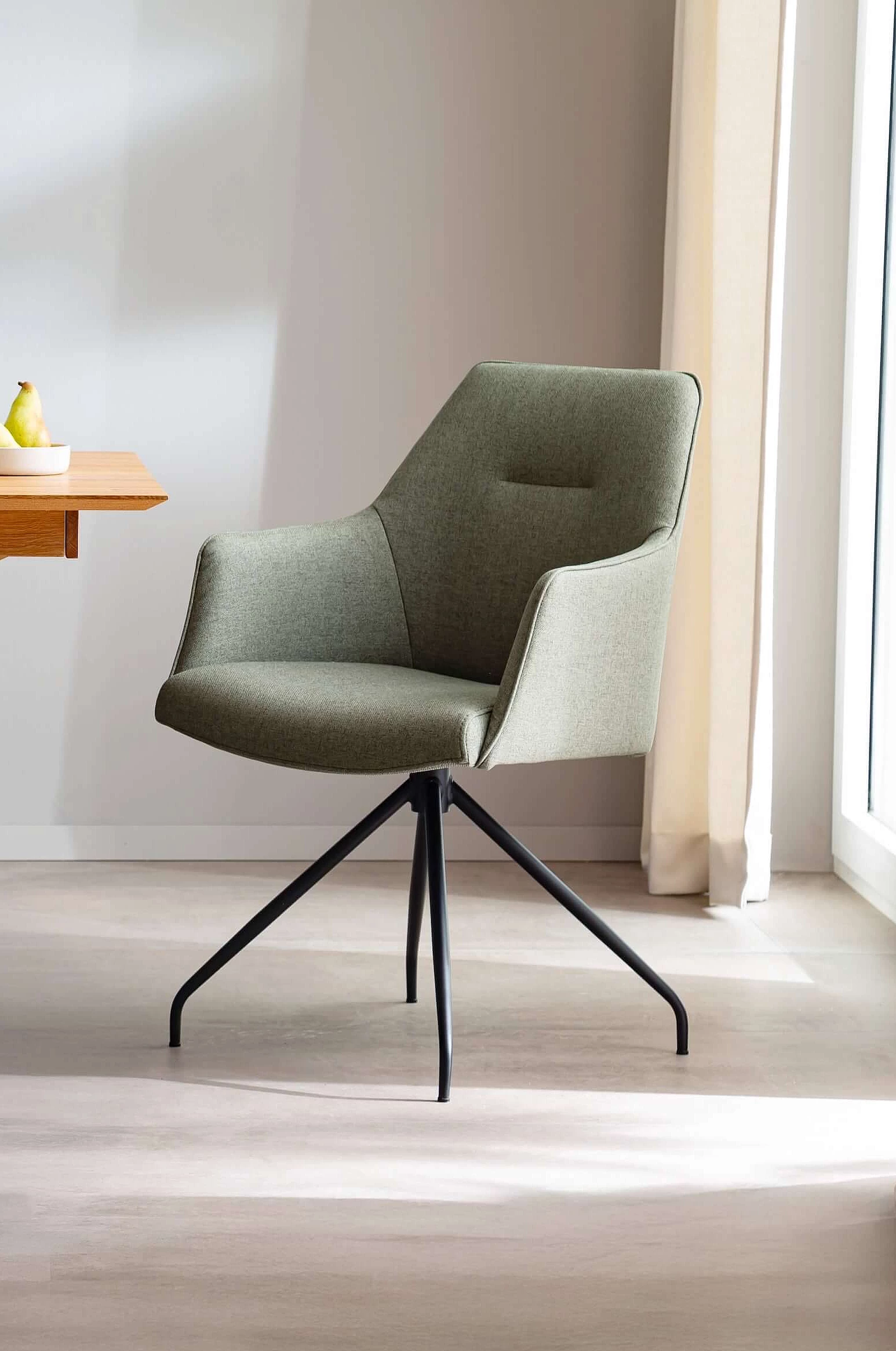 Oaklyn Chair with armrests, upholstered in Melrose fabric in the colour Olive in a cosy atmosphere
