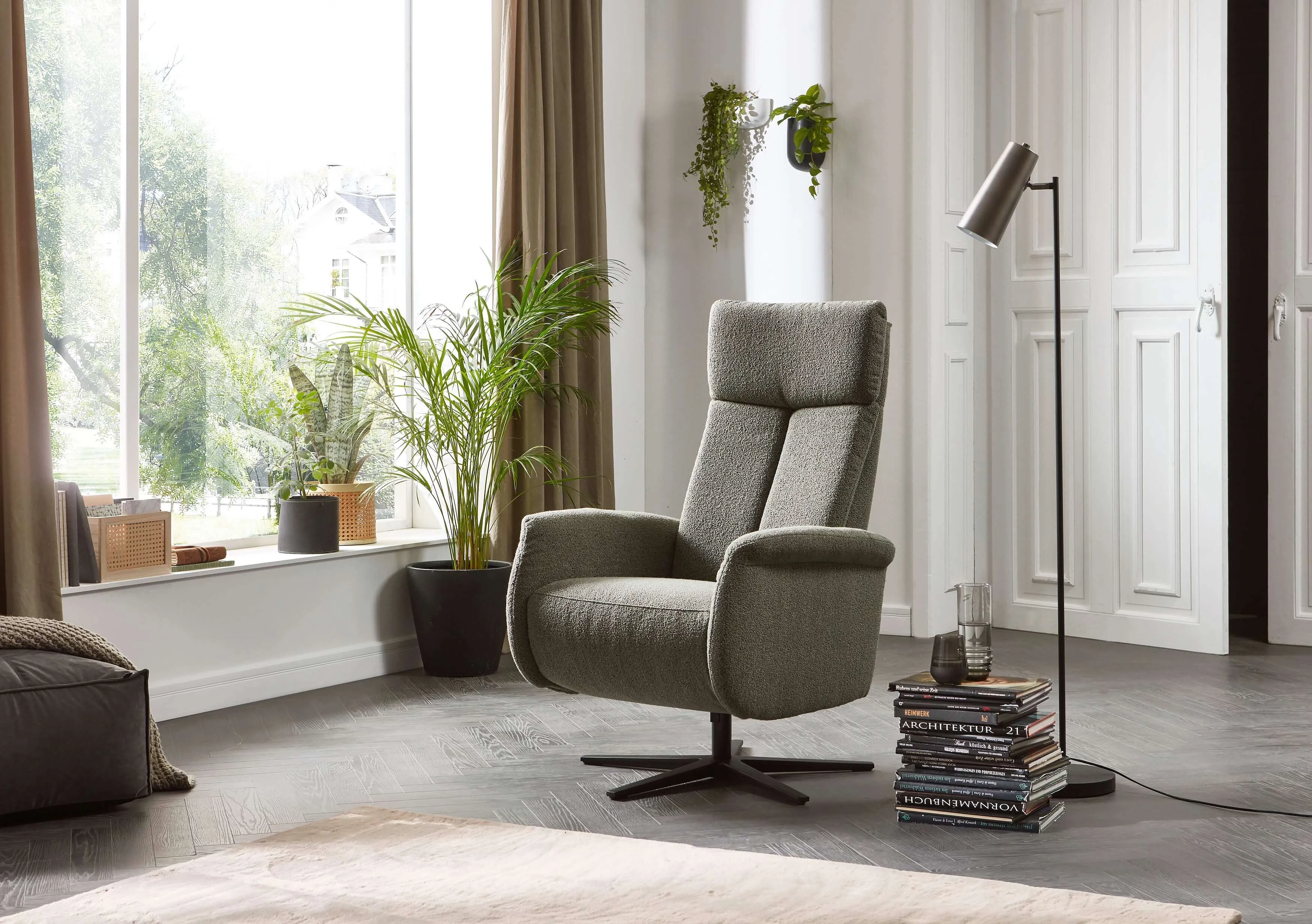 9501 Armchair upholstered in Loop fabric in the color Green in a cosy setting