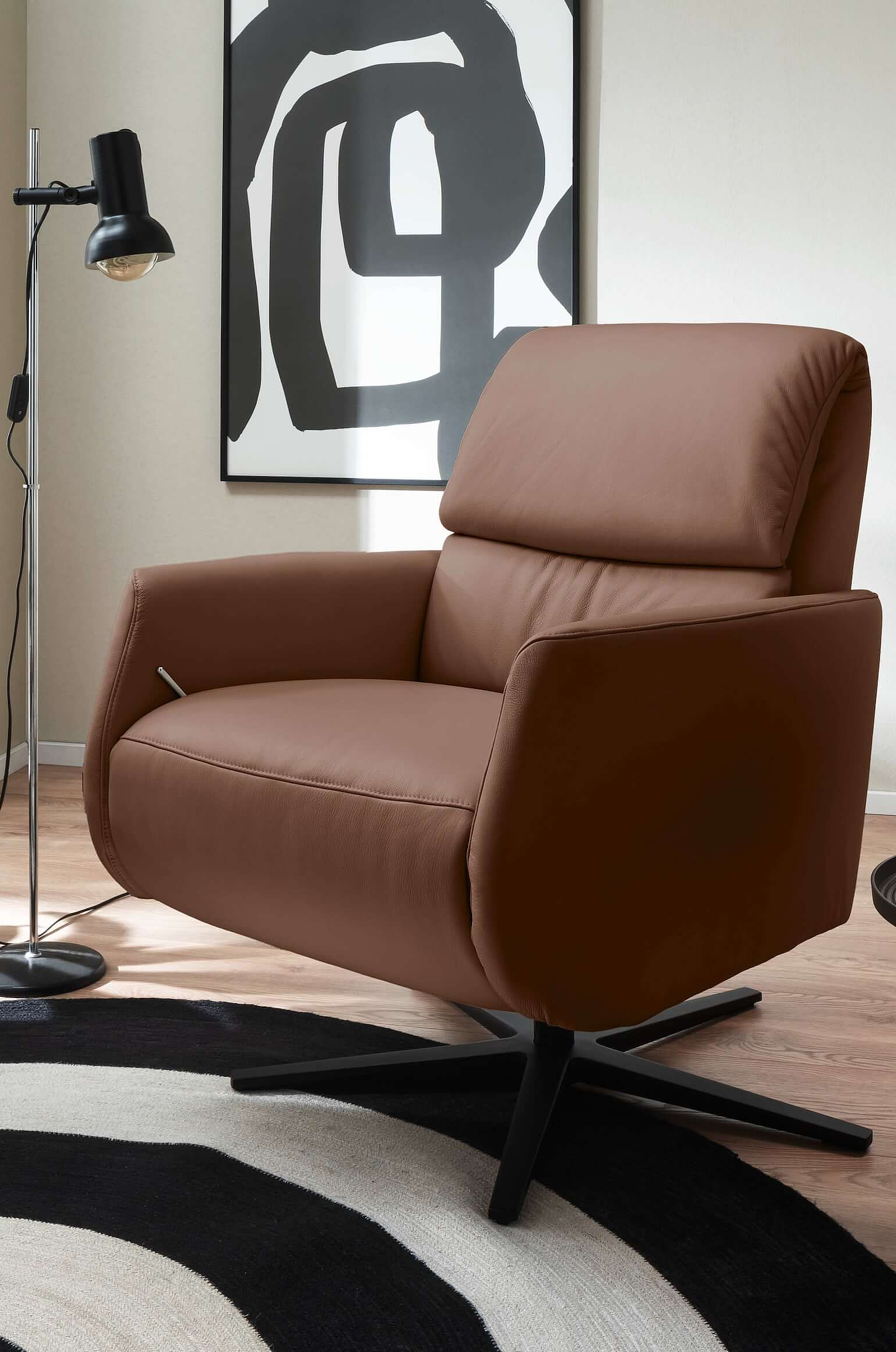 9504 Armchair upholstered in Vicenza leather in the color Brown in a cosy setting