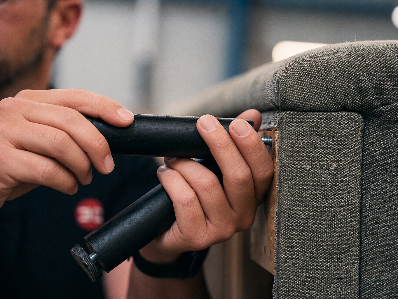 Close-up of a furniture leg being fitted on the production line