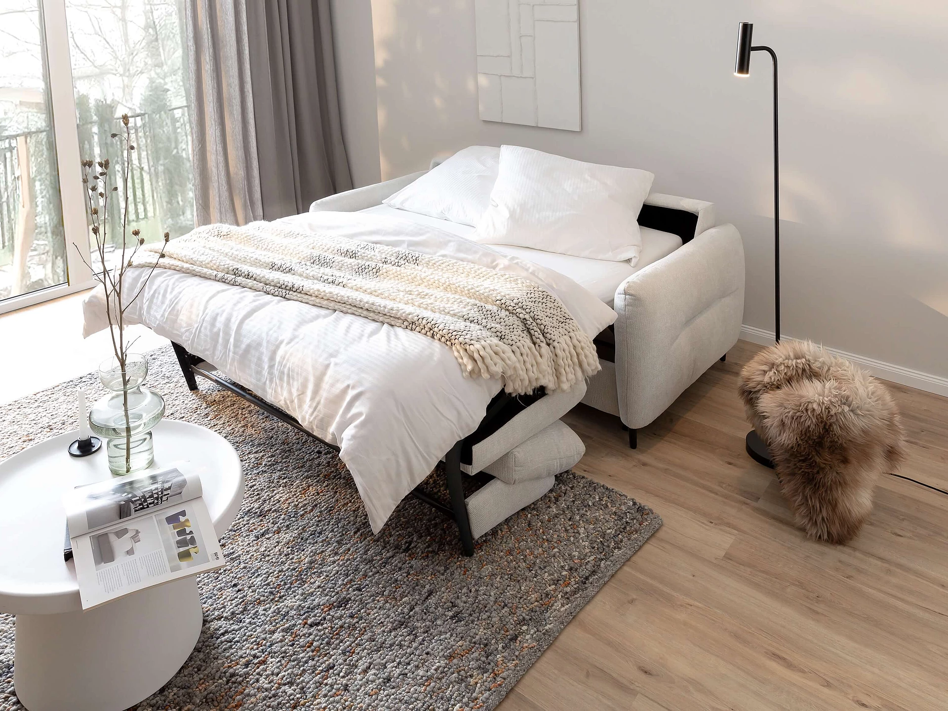 Cassie sofa bed with Famous upholstery in the colour Snow and a sleeping function in a cosy atmosphere